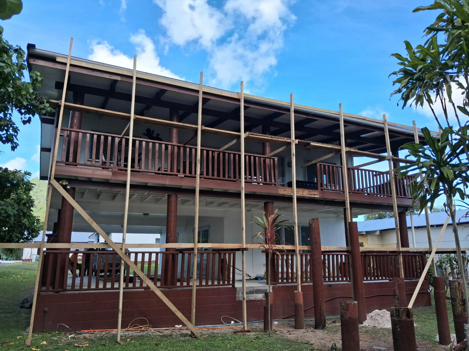 Two-storey island home under construction with timber scaffolding