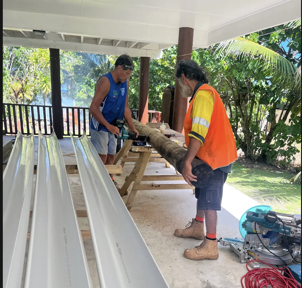 Andrew and the Teuira Build crew on site, cutting timber